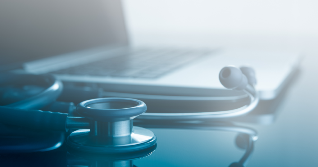 Stethoscope next to a laptop representing healthcare platforms supported by dedicated server hosting Toronto infrastructure.