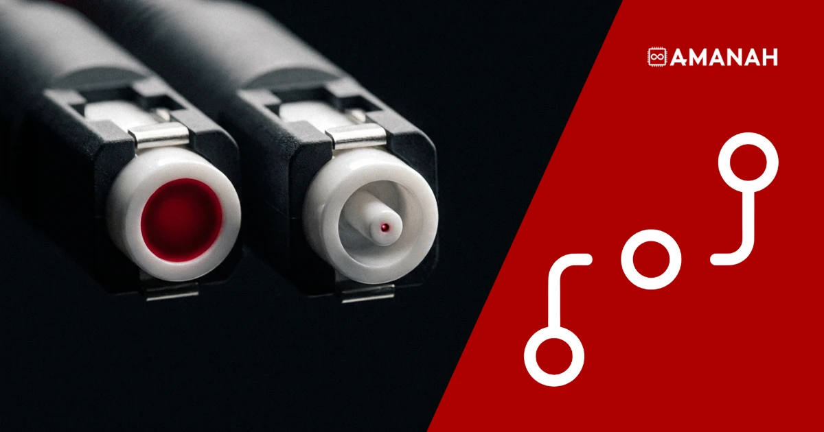 Two fibre optic connectors end-on: one wide red core, one pinpoint core, showing multimode versus single mode fibre.